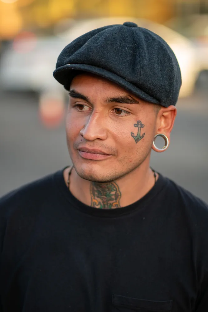 Outdoor character portrait of a man wearing a dark flat cap